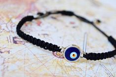 This evil eye bracelet is totally handmade in Turkey - Istanbul. Silver-plated evil eye are localized in the middle. It is black macramé which made by handmade and it is adjustable. Since it is adjustable, it is suitable for everyone. Meaning of Evil Eye : People can knowingly wish negative thoughts on you, but the power of the evil eye is that some people unknowingly and innocently cast the curse on others. That's why it's important to wear an evil eye symbol somewhere on your body or to have i Black Spiritual Friendship Bracelets With Evil Eye, Spiritual Black Friendship Bracelets With Evil Eye, Spiritual Black Evil Eye Friendship Bracelets, Spiritual Black Friendship Bracelet With Evil Eye, Handmade Black Evil Eye Bracelet For Friendship, Black Evil Eye Bracelet With Sliding Knot As Gift, Adjustable Black Evil Eye Bracelet, Handmade Round Black Friendship Bracelets, Black String Bracelet