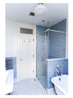 a bathroom with blue and white tiles on the floor, shower stall, tub and sink