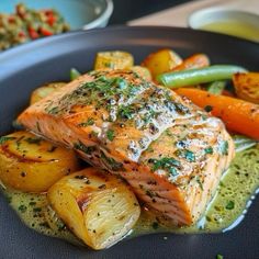 salmon, potatoes and carrots on a blue plate