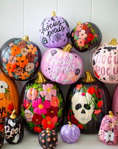 colorful painted pumpkins with flowers and skulls on them