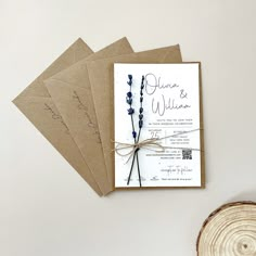 the wedding stationery is laid out on top of each other, and tied with twine