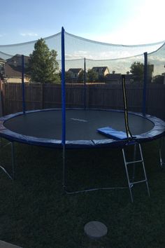 an empty trampoline in the back yard