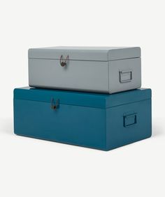 two blue and grey boxes sitting side by side on top of each other with handles