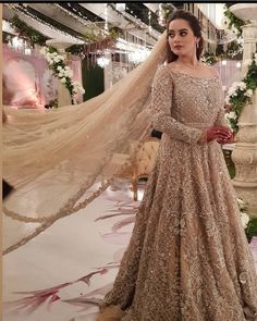 a woman standing in front of a wedding dress