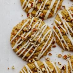 several cookies with white icing and nuts on top