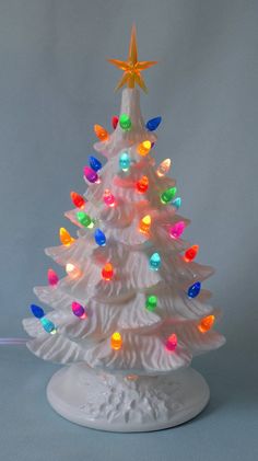 a white ceramic christmas tree with multicolored lights