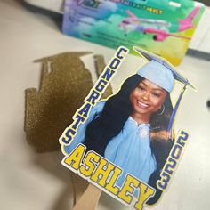 a graduation card with an image of a woman in blue cap and gown on it