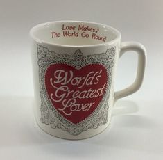 a coffee mug with the words world's greatest lover on it and a red heart