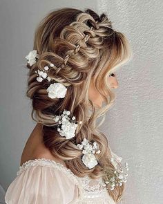 a woman with long blonde hair and flowers in her hair, wearing a wedding dress