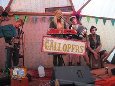 a group of people that are standing in front of a sign and some microphones