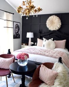 a black and white bedroom with pink accents