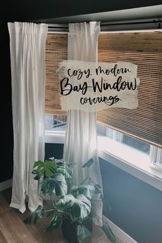 a window with the words cozy modern baby window coverings hanging on it's side