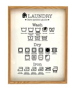 the laundry symbols are displayed in a wooden frame on a white background with black lettering