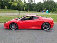 a red sports car parked in a parking lot