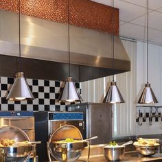 an industrial kitchen with stainless steel appliances and checkered wallpaper