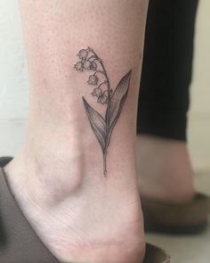 small lily of the valley tattoo on the right side of the ankle, with tiny flowers