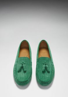 Hugs & Co. emerald tasselled loafer driving shoes for women. Moccasin style driving loafers in luxurious emerald suede upper embossed with a Gecko print pattern and lined with a soft leather for extra comfort. Made in Portugal 100% Suede Upper featuring a 100% Leather Lining Rubber studded sole Luxury Tassel Loafers With Textured Sole And Round Toe, Green Slip-on Formal Loafers, Green Slip-on Moccasins For Formal Occasions, Green Slip-on Moccasins With Leather Sole, Green Leather Sole Slip-on Moccasins, Luxury Green Slip-on Leather Shoes, Classic Green Tassel Loafers For Formal Occasions, Luxury Slip-on Tassel Loafers With Textured Sole, Formal Green Moccasins With Rubber Sole