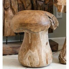 a wooden chair sitting on top of a white tile floor next to a tree stump