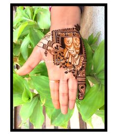 a woman's hand painted with henna art