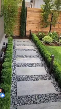 a stone path in the middle of a yard