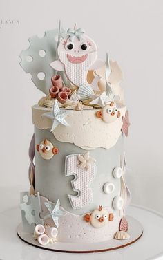 a three tiered cake decorated with sea animals