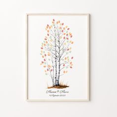 a white framed wall hanging on the side of a wall with a tree in it