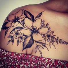 a woman's shoulder with flowers on it