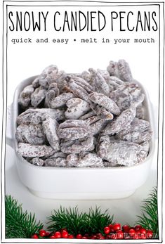 a white bowl filled with candy caned pecans sitting on top of a table