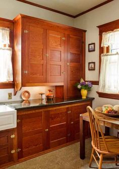 a kitchen with wooden cabinets and black counter tops