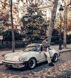 a man sitting on the hood of a parked car