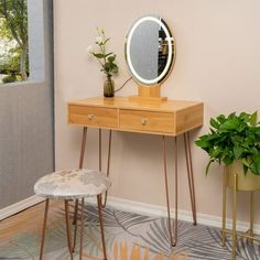 a vanity table with a mirror and stool next to potted plants on the floor