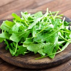 fresh green leafy greens on a wooden cutting board