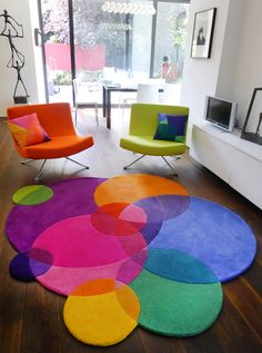 a living room filled with furniture and colorful rugs