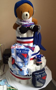 a large teddy bear sitting on top of a cake made to look like it's celebrating new york rangers