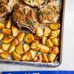 a pan filled with meat and potatoes on top of a table