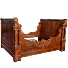 an antique wooden bed frame with carved details