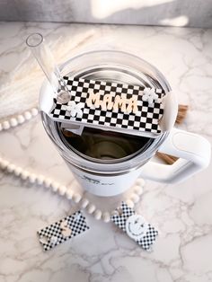 a cup filled with liquid sitting on top of a counter