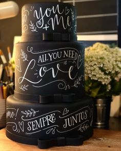 three tiered cake decorated with chalk writing