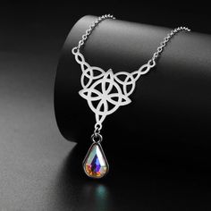 ⚜️Looking for a stunning piece of jewelry that exudes both style and spirituality? Look no further than our Celtics Knot Necklace! Crafted with Stainless Steel and adorned with a mesmerizing Crystal Rhinestone, this necklace will add a touch of magic to any outfit. Complete with an elegant pendant size of 32.5*27.9mm, it's the perfect accessory for any witch or crystal lover. Add it to your collection today and let its powerful energy guide you on your journey! ✨🔮 Mystical Clavicle Chain Jewelry As Gift, Mystical Clavicle Chain Jewelry For Gift, Crystal Teardrop Pendant Clavicle Necklace, Crystal Clavicle Chain Necklace With Teardrop Pendant, Mystical Teardrop Jewelry For Jewelry Making, Bohemian Silver Crystal Clavicle Chain Necklace, Silver Crystal Pendant Necklace With Jewels, Silver Pendant Crystal Necklace With Jewels, Bohemian Silver Crystal Necklace With Clavicle Chain