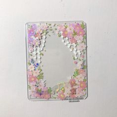 an image of a mirror with flowers and butterflies on the frame, made out of acrylic paint