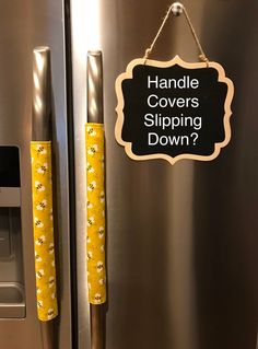 a stainless steel refrigerator with yellow flowers on the door and handle covers slipping down