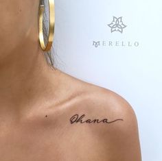 a woman with a tattoo on her chest and the word ohana written in cursive ink