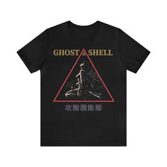 Introducing our unique Ghost in The Shell vintage t-shirt, a perfect addition to any manga and anime lover's wardrobe! This unisex retro graphic tee combines the timeless appeal of classic Japanese animation with a touch of nostalgia.  Printed on premium high quality Bella + Canvas soft t-shirts.  * Processing and Shipping Times - Please allow 3-5 business days for your order to be processed and made - Standard shipping takes 3-5 days - Please make sure your shipping address is correct before pl Pop Culture T-shirt With Letter Print For Cosplay, Fandom Graphic Print T-shirt For Streetwear, Graphic Tee For Fan Gatherings, Pop Culture T-shirt With Graphic Print For Cosplay, Pop Culture T-shirt For Cosplay With Letter Print, Band Merch T-shirt With Letter Print For Conventions, Harajuku Style Screen Print T-shirt For Fan Conventions, Fandom Style T-shirt With Screen Print For Fan Gatherings, Cosplay Graphic Tee With Screen Print