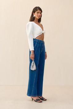 A wide leg, paneled denim pant with a high waist and back pockets. — High waisted — Full length — Diagonal, paneled design — Belt loops — Back pockets Chic High Rise Pants With Seam Detailing, Denim Blue Wide Leg Pants With Seam Detailing, Bridal Tops, Short Loungewear, Drape Sleeves, Kick Flares, Cult Gaia, Knit Crop Top, Knit Crop