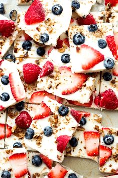 sliced strawberries, blueberries and granola arranged on top of each other