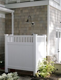 a white fence in front of a house