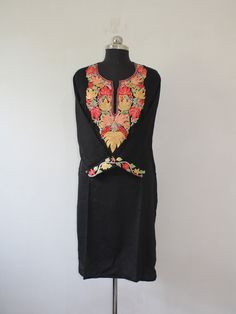 Embrace effortless elegance with a Kashmiri Aari embroidered cotton kurti.The cool, breathable comfort of cotton is elevated by the meticulous artistry of Aari work. This traditional embroidery technique utilizes a long needle to create stunning designs directly onto the fabric. Imagine delicate floral patterns, geometric motifs, or even enchanting paisleys adorning the kurti, each stitch imbued with the skill of Kashmiri artisans. The result is a garment that's both beautiful and versatile, perfect for adding a touch of cultural flair to your everyday wardrobe. Product Details - Condition: Brand New - Handmade - Style: Kurti Tunic - Fabric: Ruby Cotton - Embroidery: Kashmiri Aari Embroidery - Embroidery Color: blue - Kurti Length: 42" Inch - Kurti Chest: 42'' Inch - Care Instructions: Han Bohemian Chanderi Kurta With Embroidered Neckline, Chanderi Straight Kurta Set With Embroidered Neckline, Bohemian Cotton Silk Kurta With Floral Embroidery, Unstitched Anarkali Kurta With Embroidered Neckline, Eid Cotton Silk Kurta With Embroidered Neckline, Traditional Chanderi Kurta With Embroidered Neckline, Traditional Unstitched Embroidered Dress With Straight Kurta, Bohemian Embroidered Cotton Silk Salwar Kameez, Traditional Straight Kurta With Embroidered Neckline