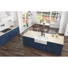 an aerial view of a kitchen with blue cabinets and white counter tops, along with a dining room table