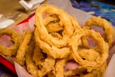 some onion rings are sitting in a basket