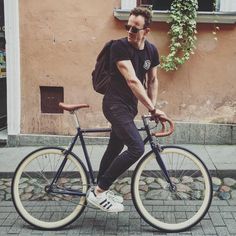 a man is standing next to his bike